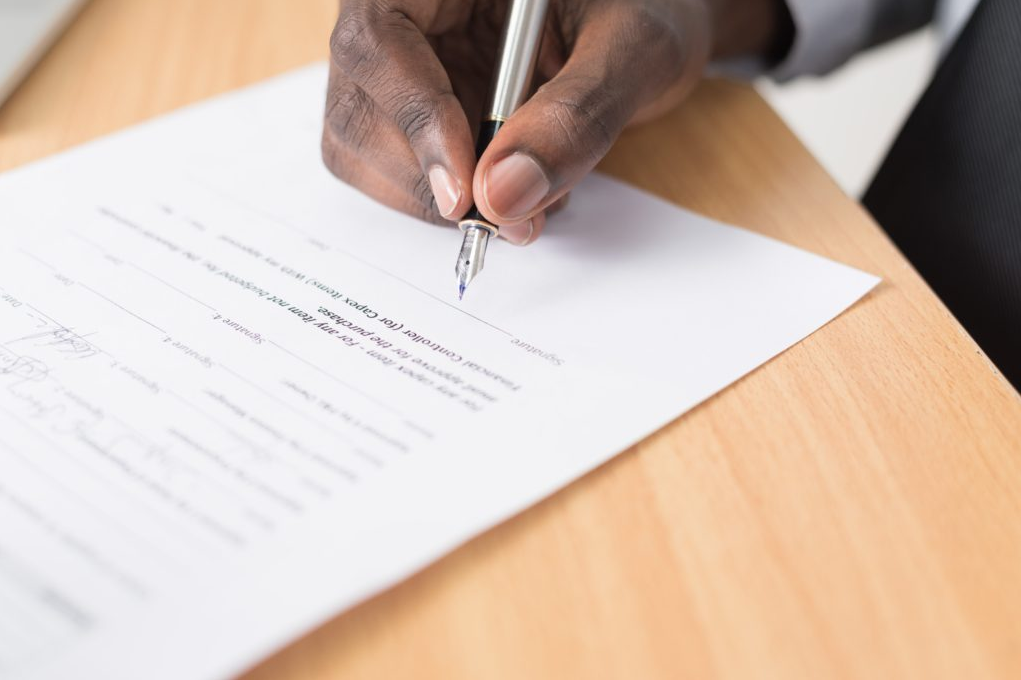 A business owner signing a contract where there is a breach of contract